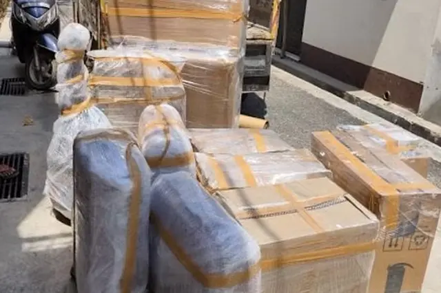 Furniture and boxes wrapped in protective material for moving